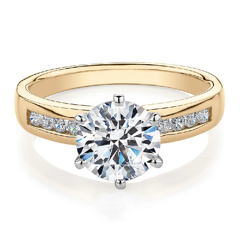 Round Brilliant shouldered engagement ring with 2.2 carats* of diamond simulants in 14 carat yellow and white gold